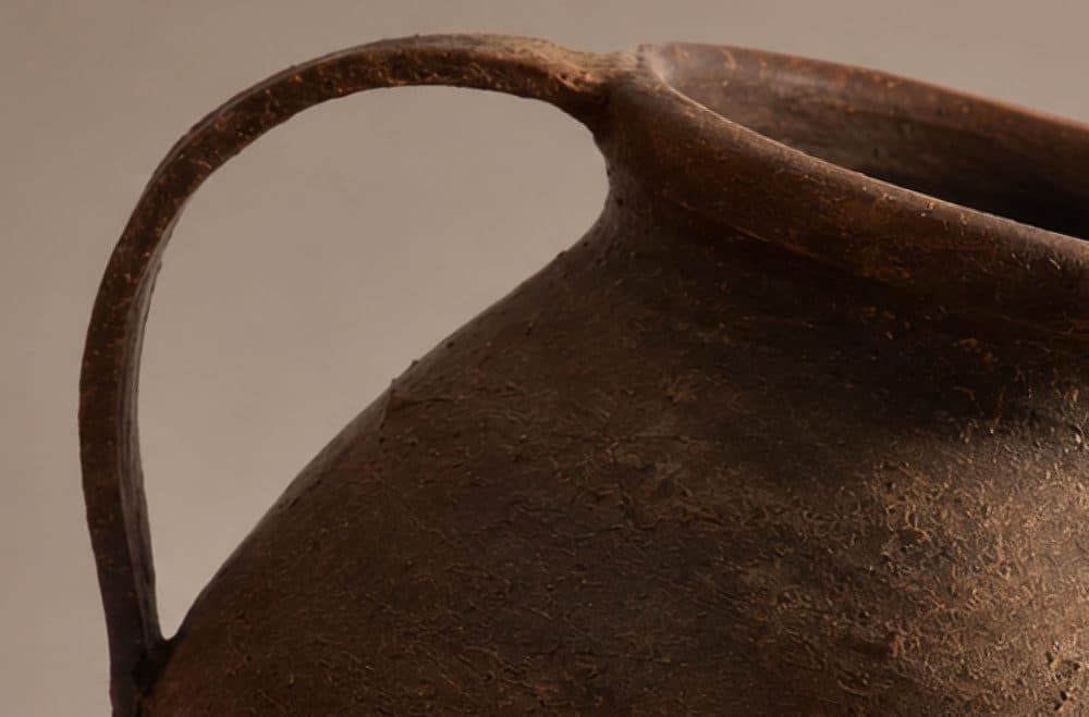 A brown clay pot with a strap handle on a Canggu Home social post.