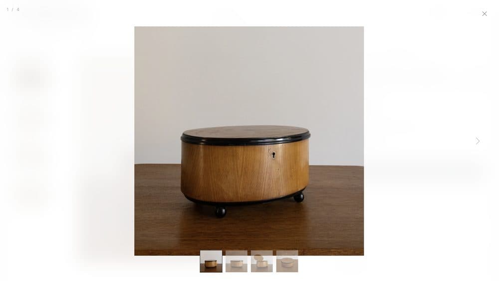 A store product page showing a wooden lidded box on white with small thumbnails below.