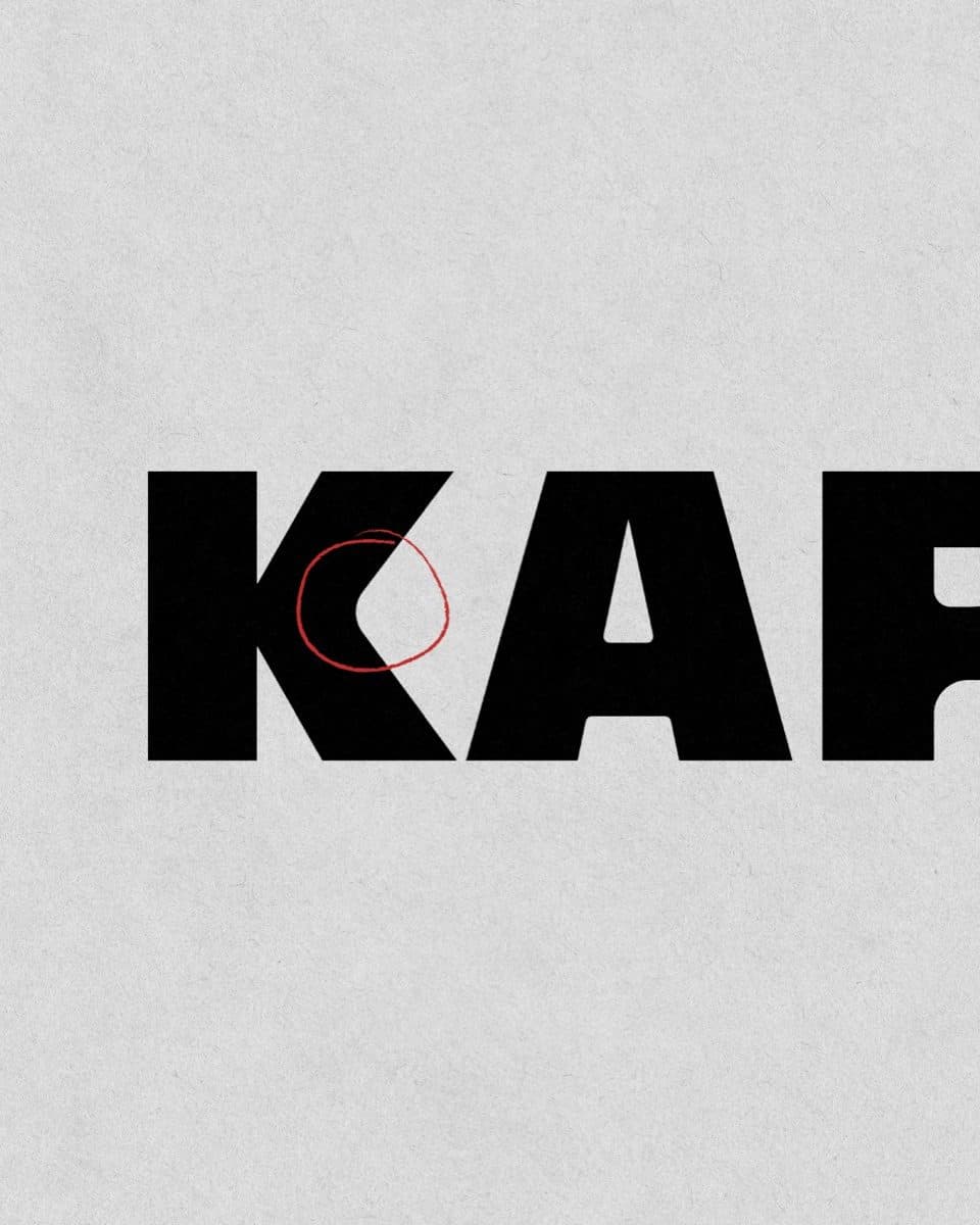 Large black letters spelling Kaparti on grey paper, cropped at the right edge, with a thin red circle drawn on the K.