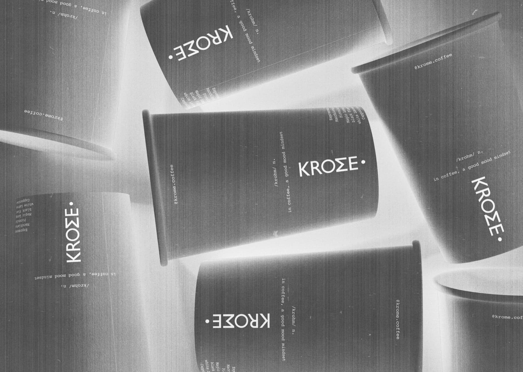 Black paper cups printed with the Krome wordmark, scattered in grey tones.