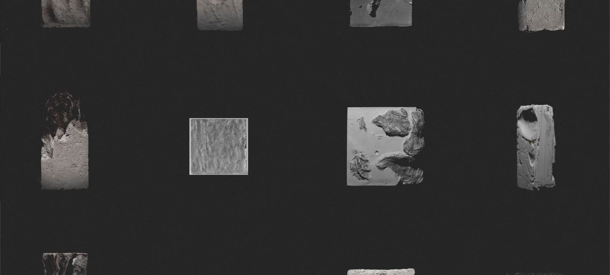 A grid of small material samples in pale stone and grey tones on a near-black ground.