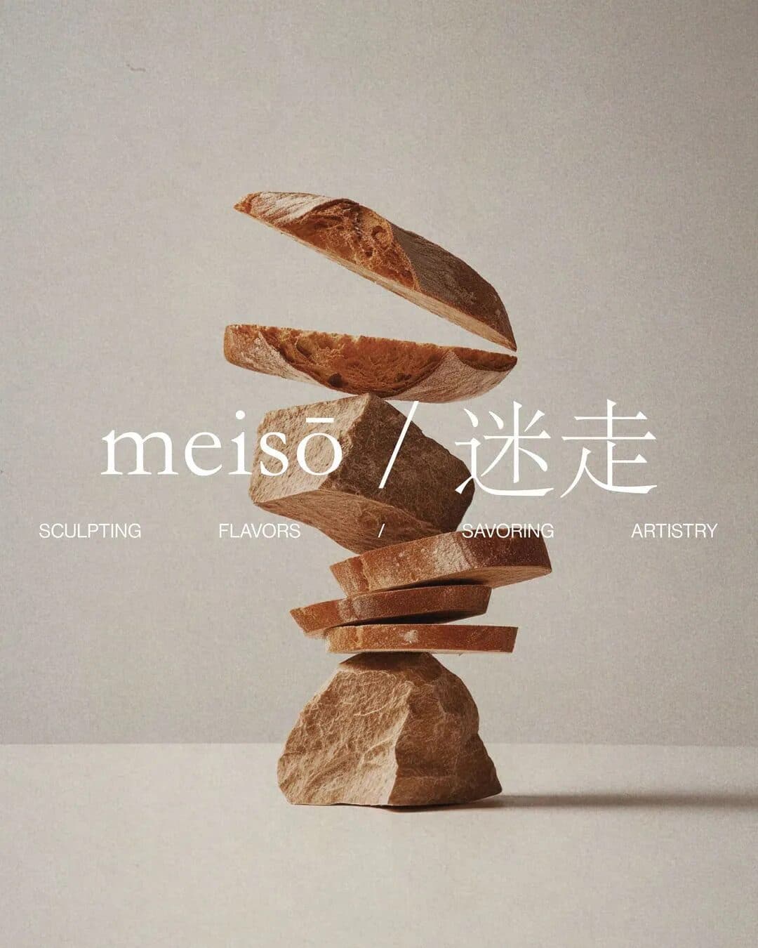 Sliced bread stacked on a rough stone, with the meisō wordmark in white across the middle.