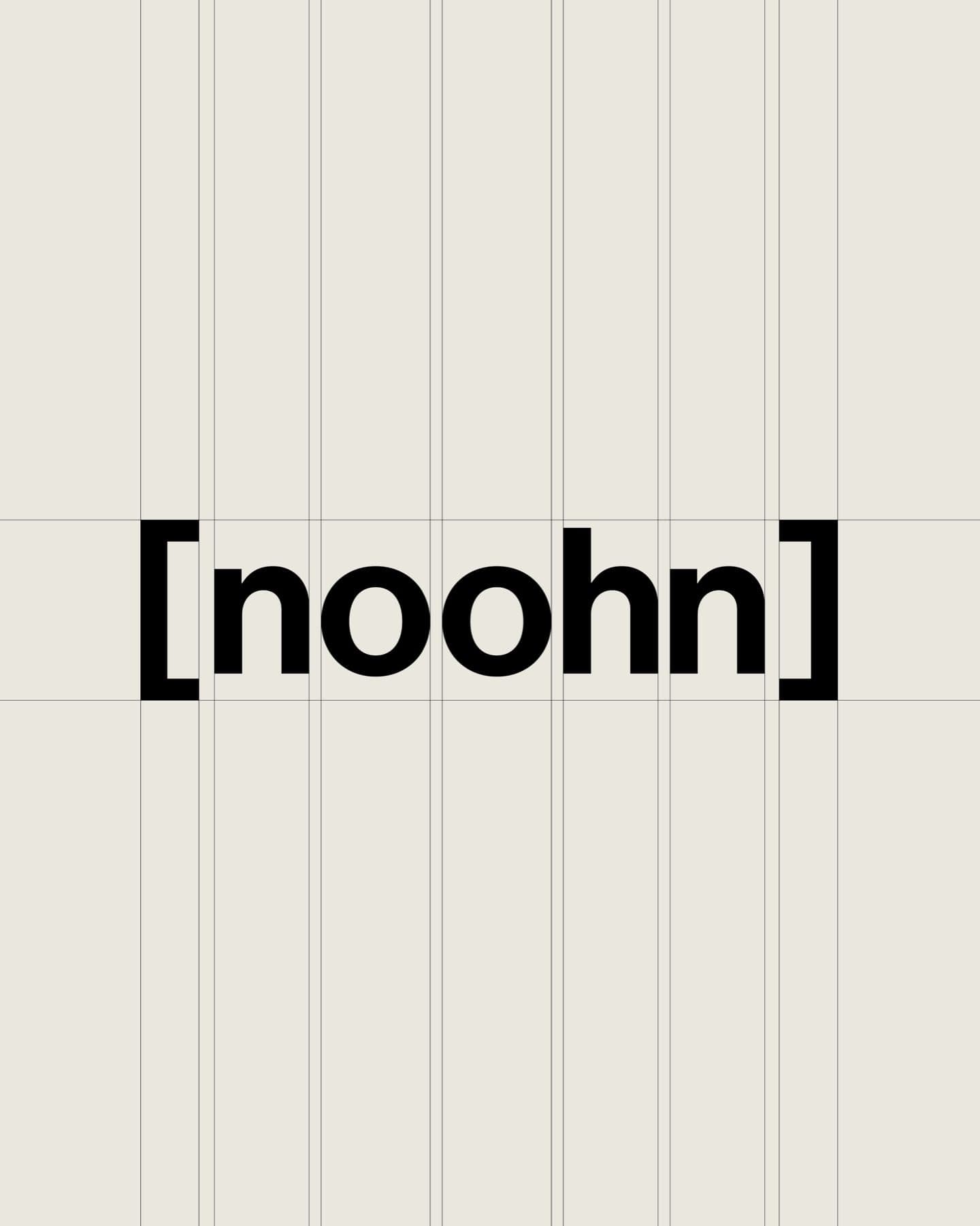 The black noohn wordmark centred on a warm off-white ground with thin vertical guide lines.