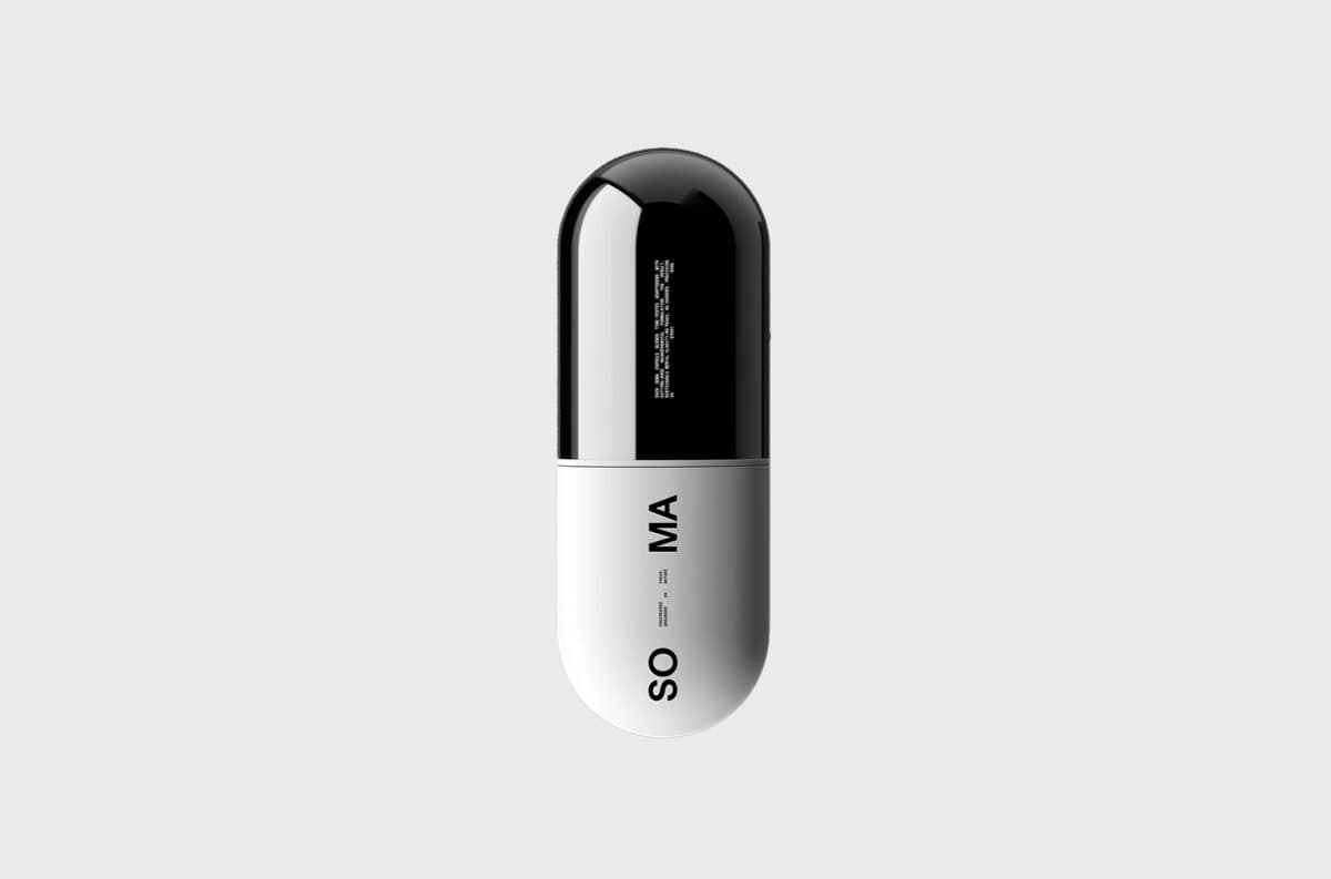 A capsule standing upright on a pale grey ground, black in the top half and white in the bottom half, with SO MA printed vertically.