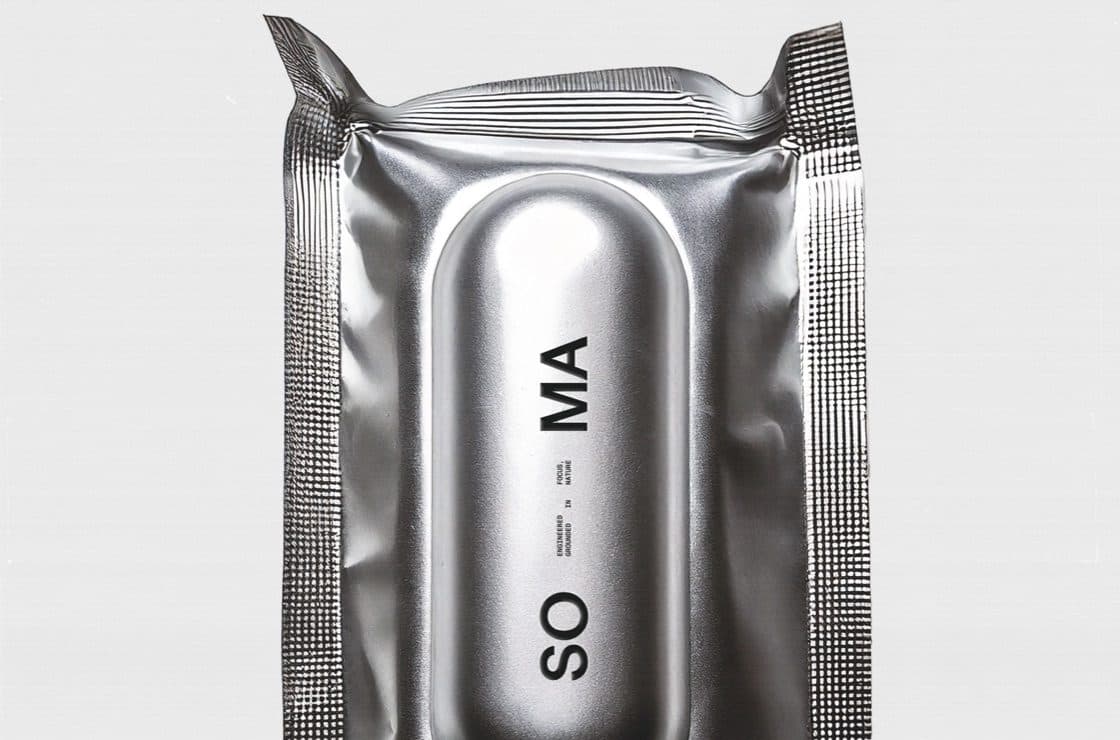 A silver foil sachet with a raised capsule shape in the centre and the letters SO MA printed along it.