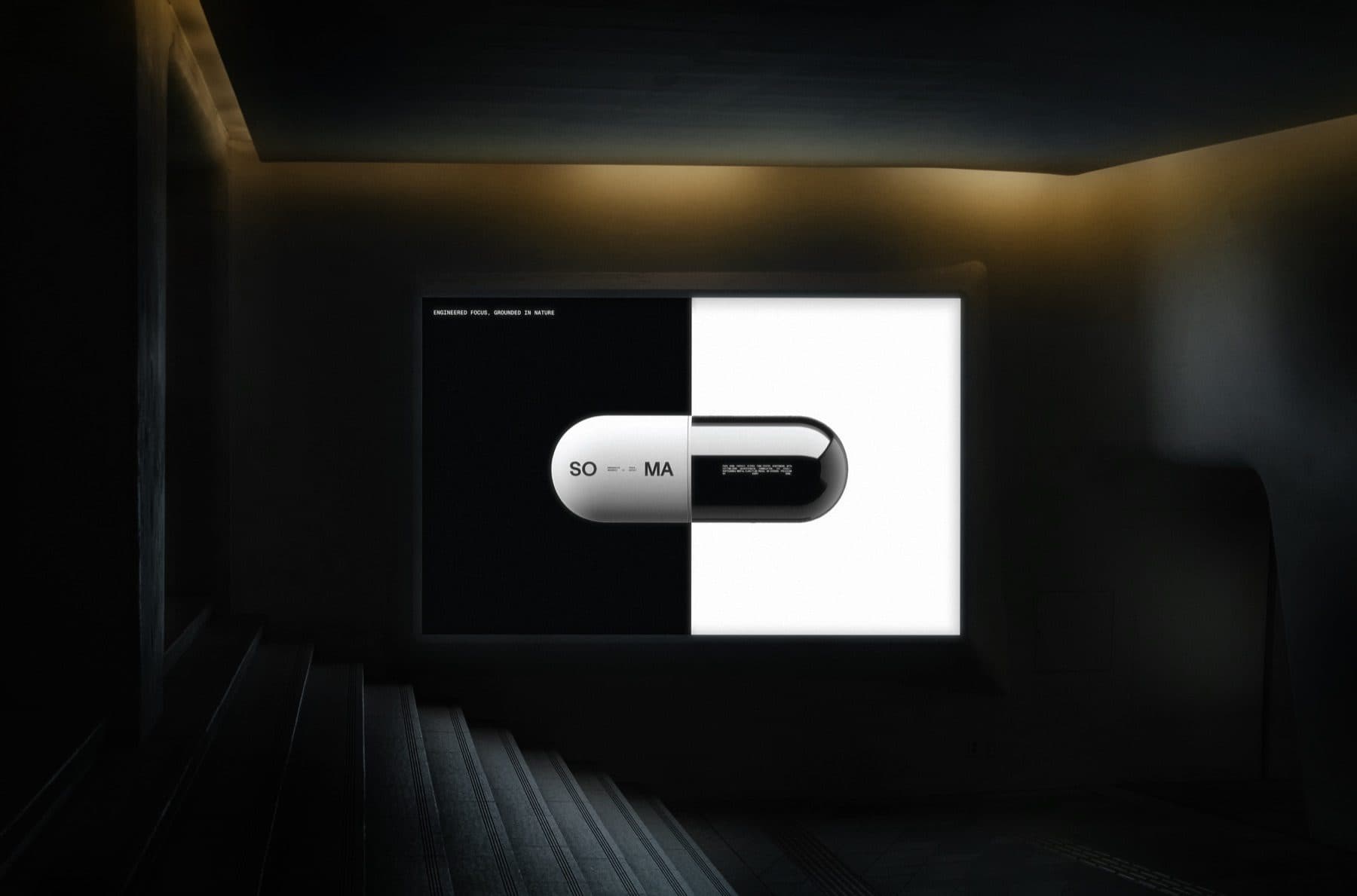 A large screen on the wall of a dark, empty hall showing a capsule set between a black square and a white square.