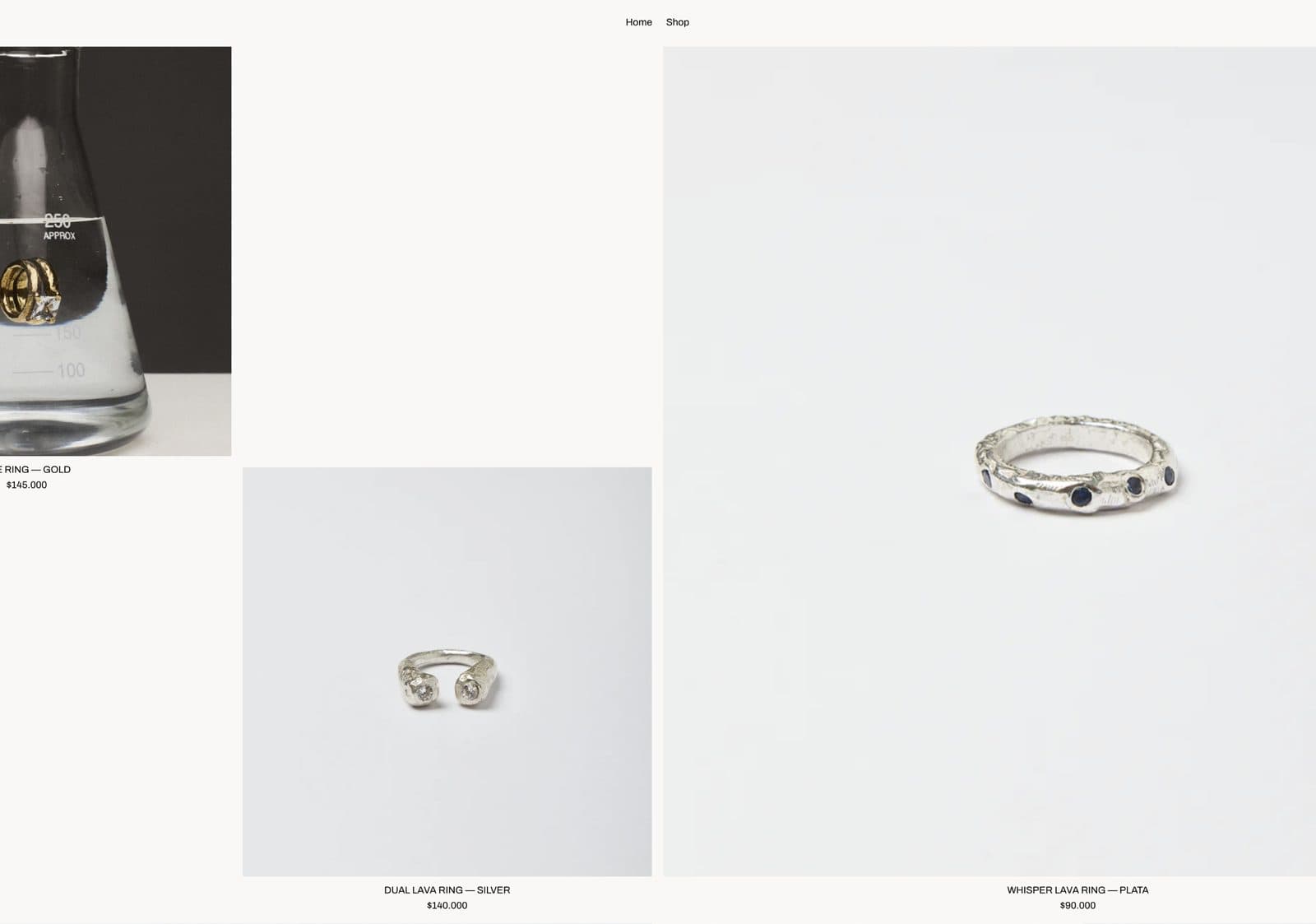 A shop page with a large silver ring with dark stones on a pale ground, beside smaller product tiles.