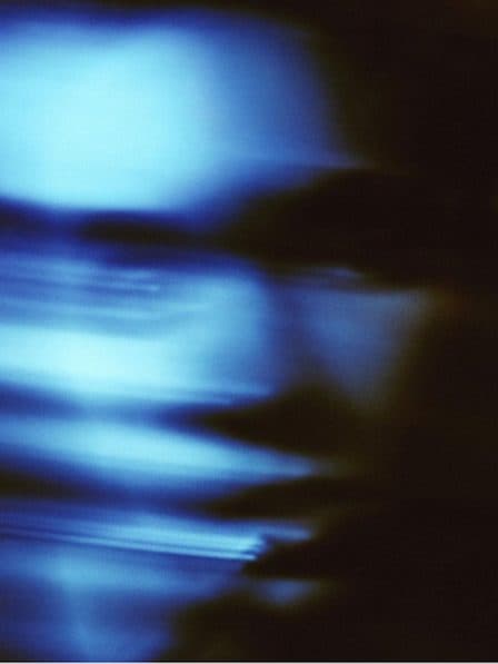 Streaks of blue light on a dark ground.