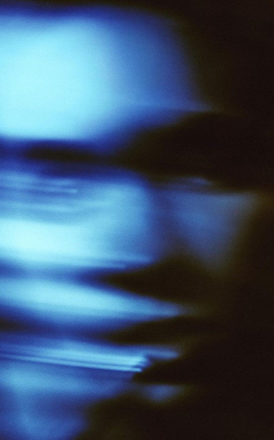 Streaks of blue light on a dark ground.