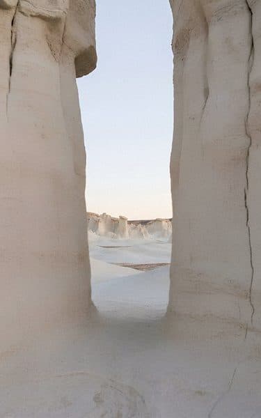 Tall pale stone pillars framing a strip of sky.