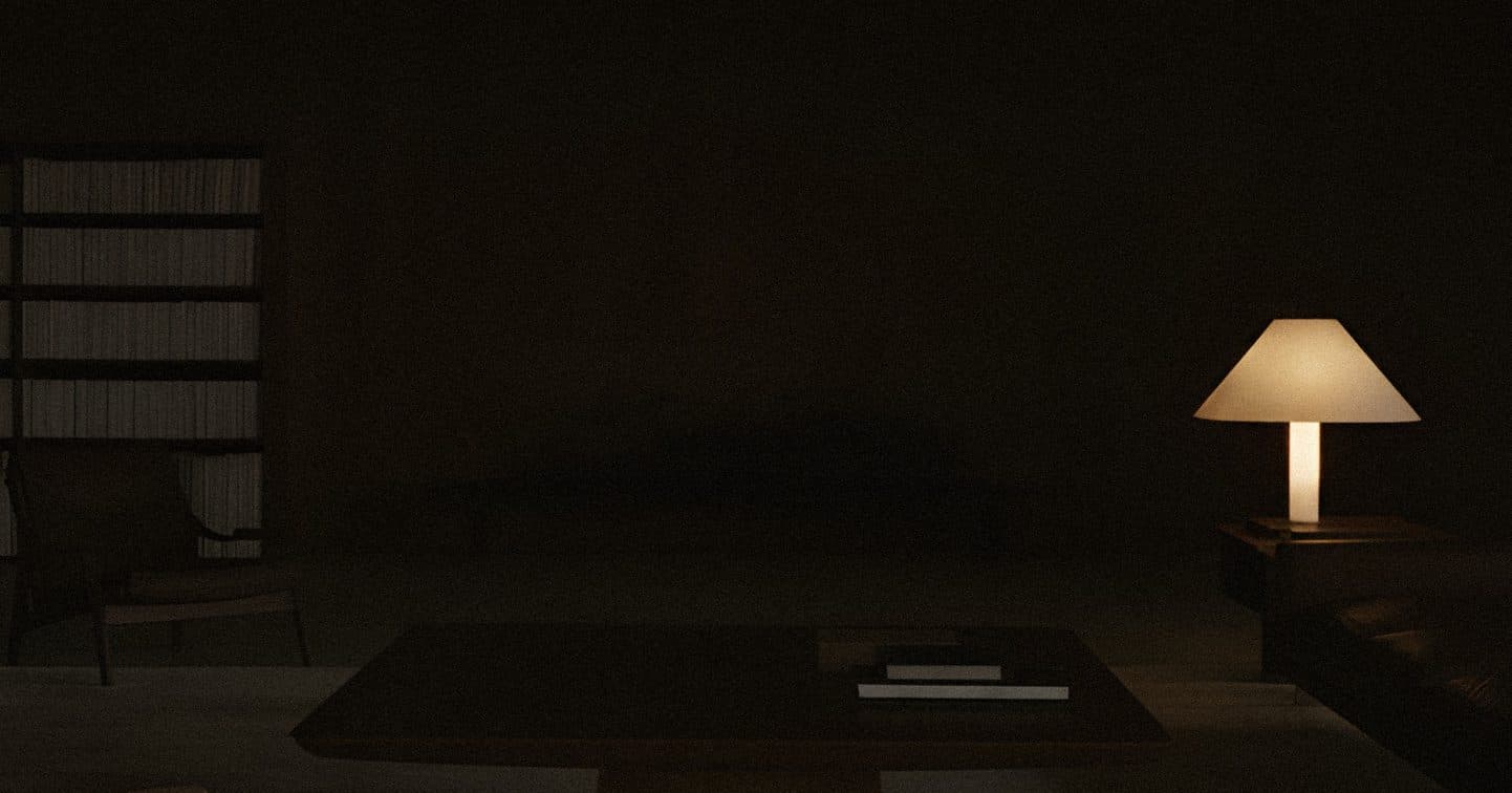 A dark living room with a low table and shelves, and one cone-shaped lamp glowing warm at the right.