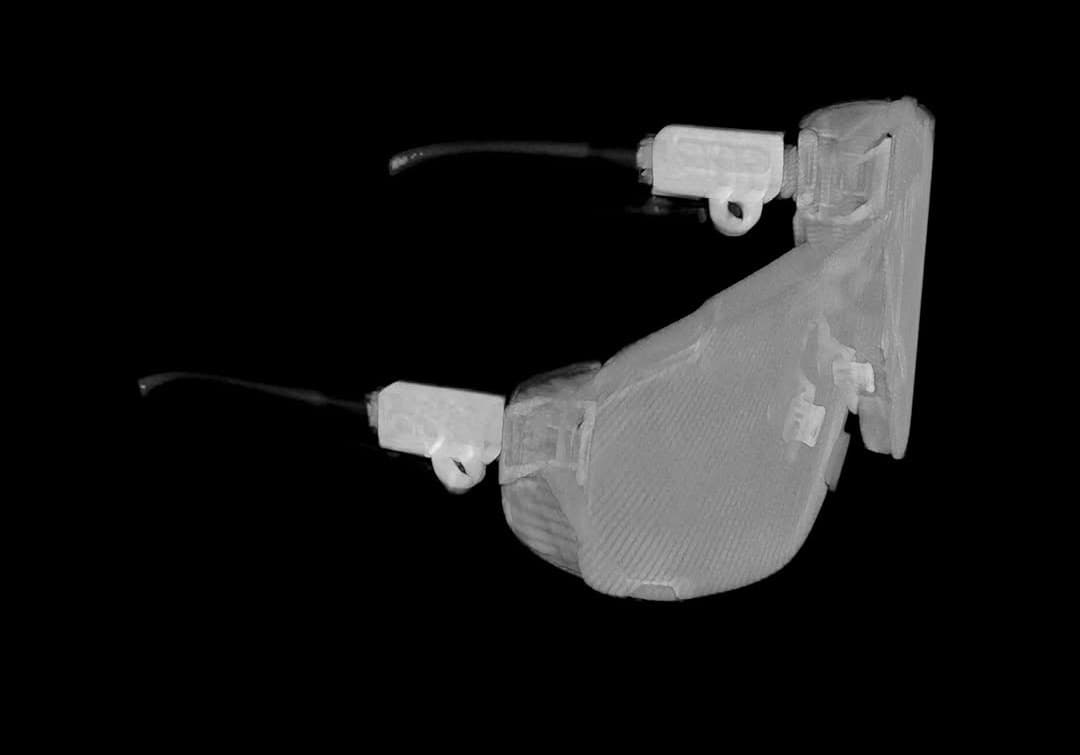 A dark product shot of clear protective goggles.
